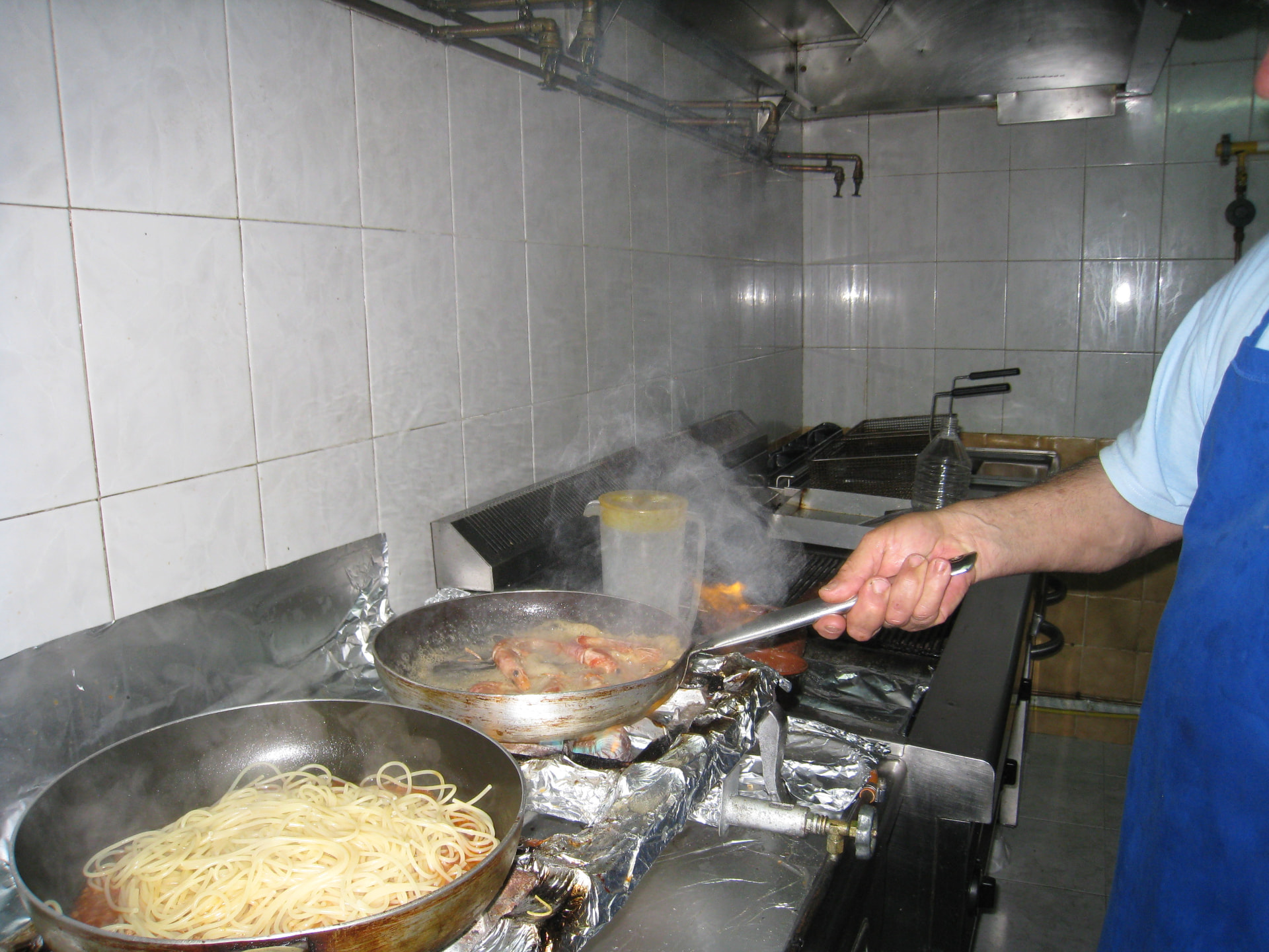 Fresh shrimp and pasta cooking in the taverna kitchen