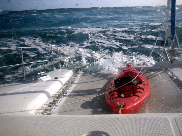 Leaving Tahiti, waves breaking across pass